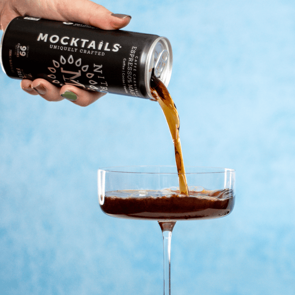 Hand pouring Nitro Mocktails Espress0% Martini Non-Alcoholic Cocktails into a glass—alcohol-free espresso martini with notes of vanilla, cocoa, and coffee.