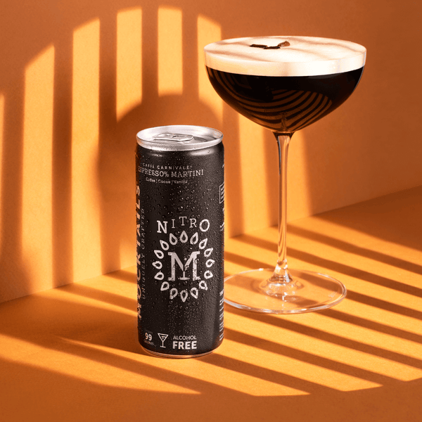 Nitro Mocktails Espress0% Martini can beside a foamy non-alcoholic espresso martini in coupe glass—nitro-infused coffee mocktail.