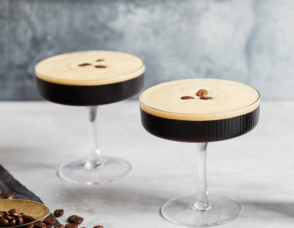 Classic non-alcoholic espresso martini made with Nitro Mocktails Espress0% Martini served in a coupe glass garnished with 3 coffee beans