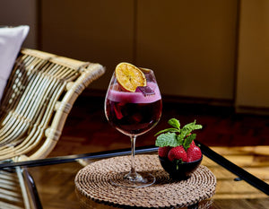 Classic non-alcoholic sangria made with Nitro Mocktails Sansgria served in a wine glass in a lifestyle setting