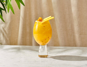Tropical Kick mocktail made with Nitro Mocktails Mockscow Mule, garnished with mango and chili flakes