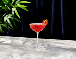 Strawberry Shrub Daiquiri using Nitro Mocktails Mockapolitan with citrus and berry garnish in coupe glass